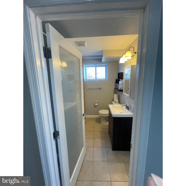 bathroom featuring vanity, toilet, and tile patterned flooring