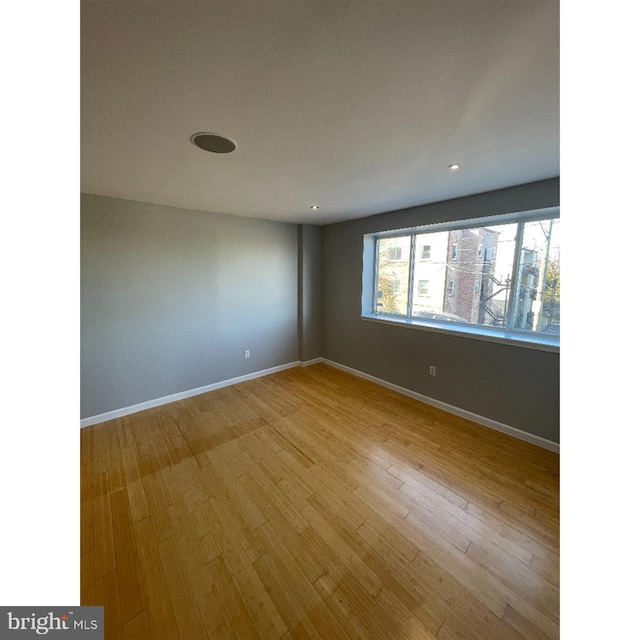 spare room featuring hardwood / wood-style flooring