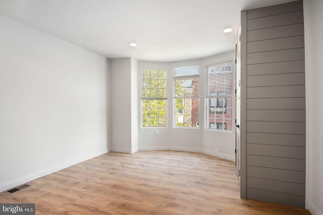 empty room with light hardwood / wood-style flooring