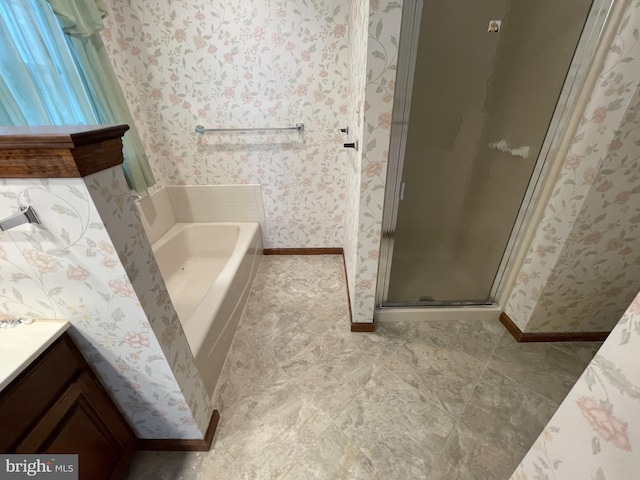 bathroom with vanity and shower with separate bathtub