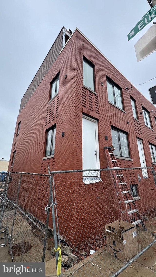 view of building exterior featuring fence