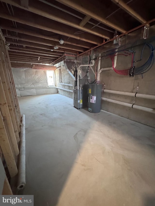 basement featuring heating unit and water heater