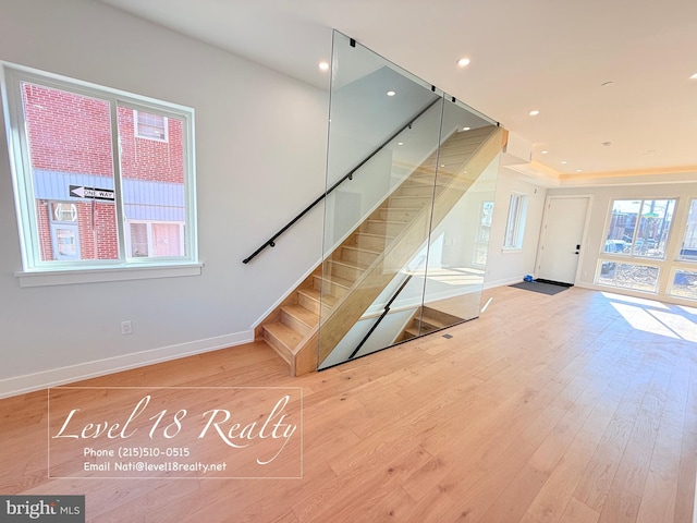 interior space featuring baseboards, wood finished floors, and recessed lighting