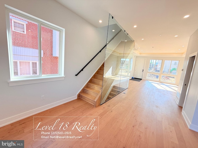 stairs with hardwood / wood-style floors, baseboards, and recessed lighting