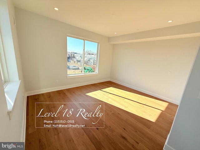 unfurnished room featuring recessed lighting, baseboards, and wood finished floors