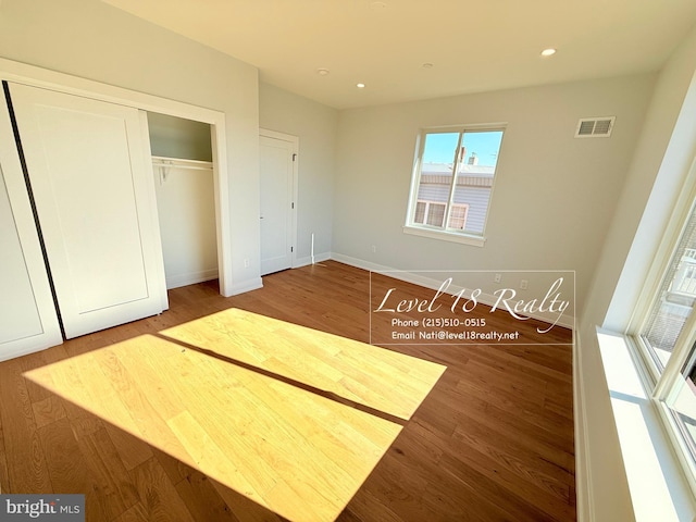 unfurnished bedroom featuring wood finished floors, recessed lighting, and visible vents