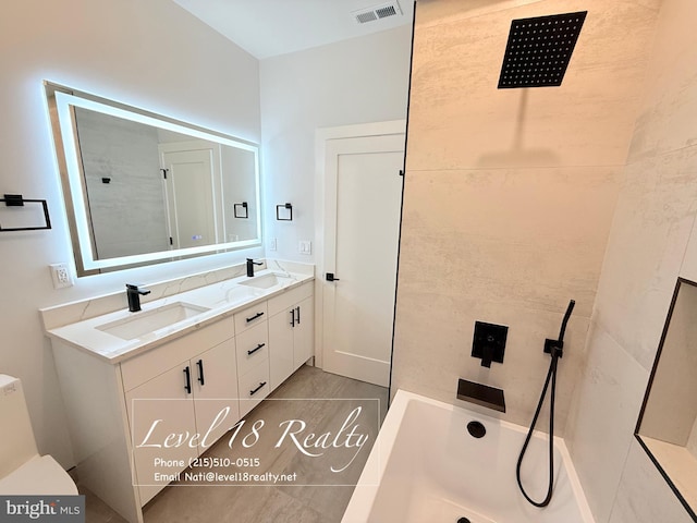 full bathroom with a tub, double vanity, visible vents, and a sink