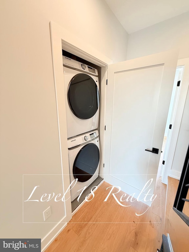 washroom featuring stacked washing maching and dryer and laundry area