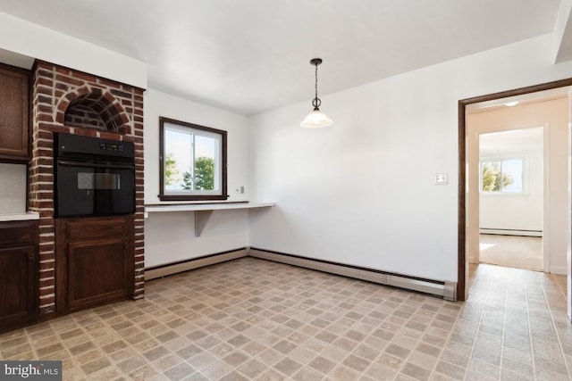 kitchen featuring a baseboard heating unit, dark brown cabinetry, hanging light fixtures, and oven