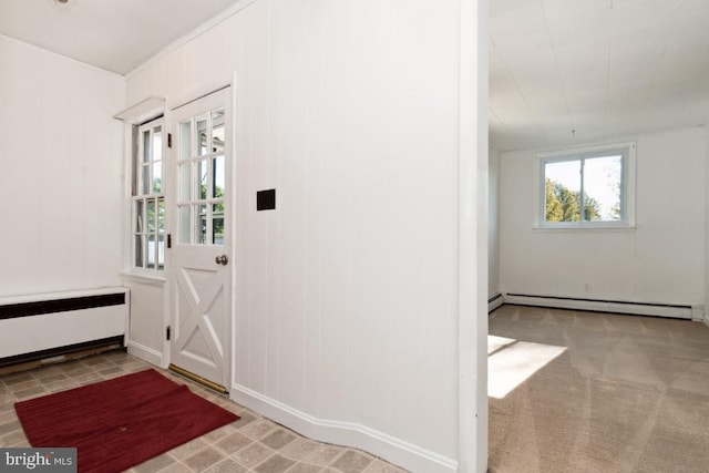 carpeted entrance foyer with radiator heating unit and baseboard heating