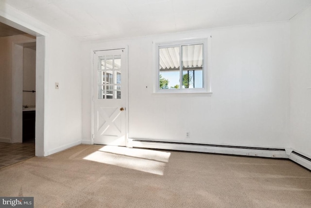 empty room with light carpet and a baseboard heating unit