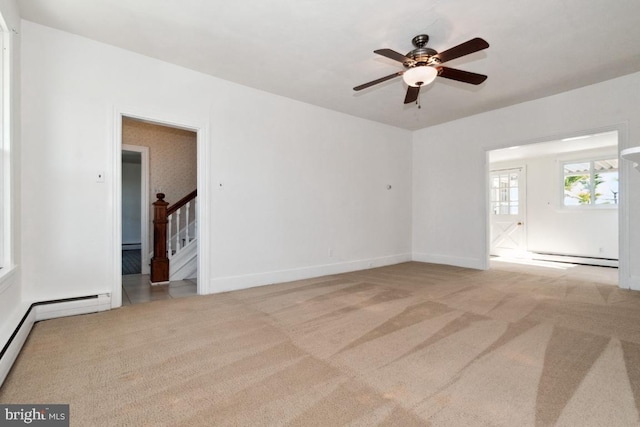 carpeted empty room featuring ceiling fan