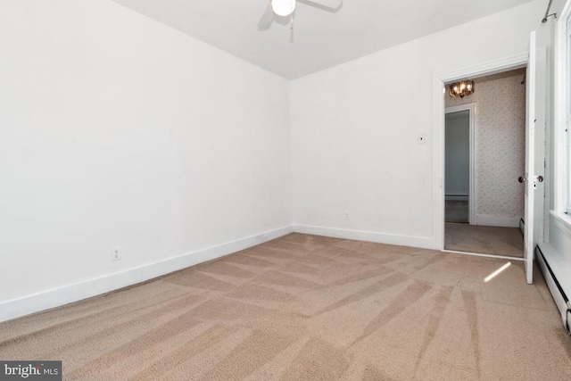 unfurnished bedroom featuring ceiling fan, light carpet, and baseboard heating