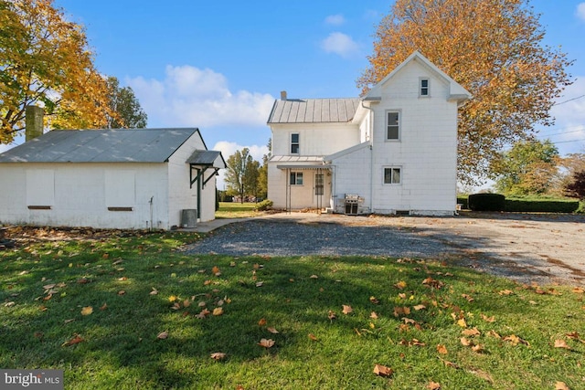 back of house with a lawn