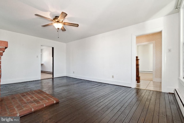 unfurnished living room featuring a baseboard heating unit, a ceiling fan, hardwood / wood-style flooring, and baseboards