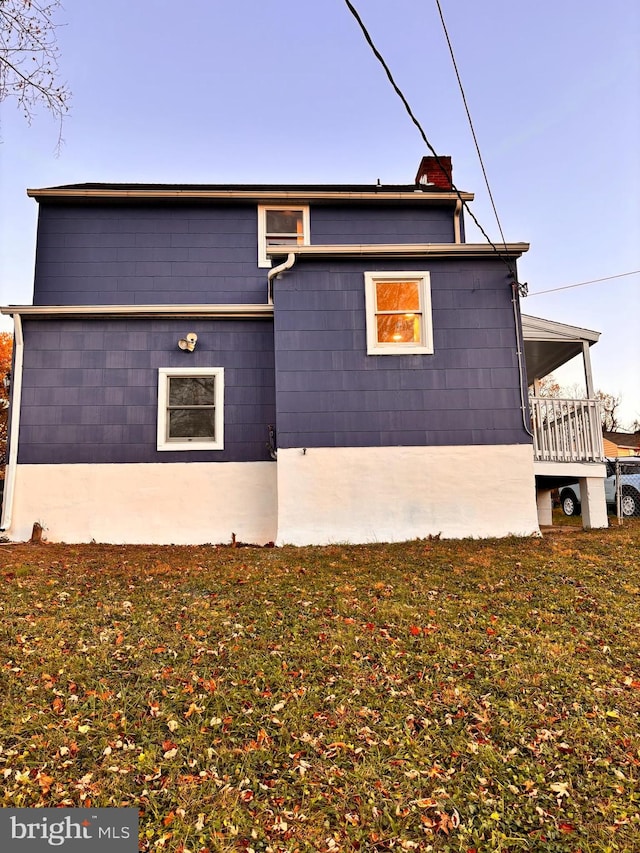 view of side of home featuring a yard