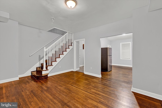 unfurnished living room featuring dark wood-type flooring