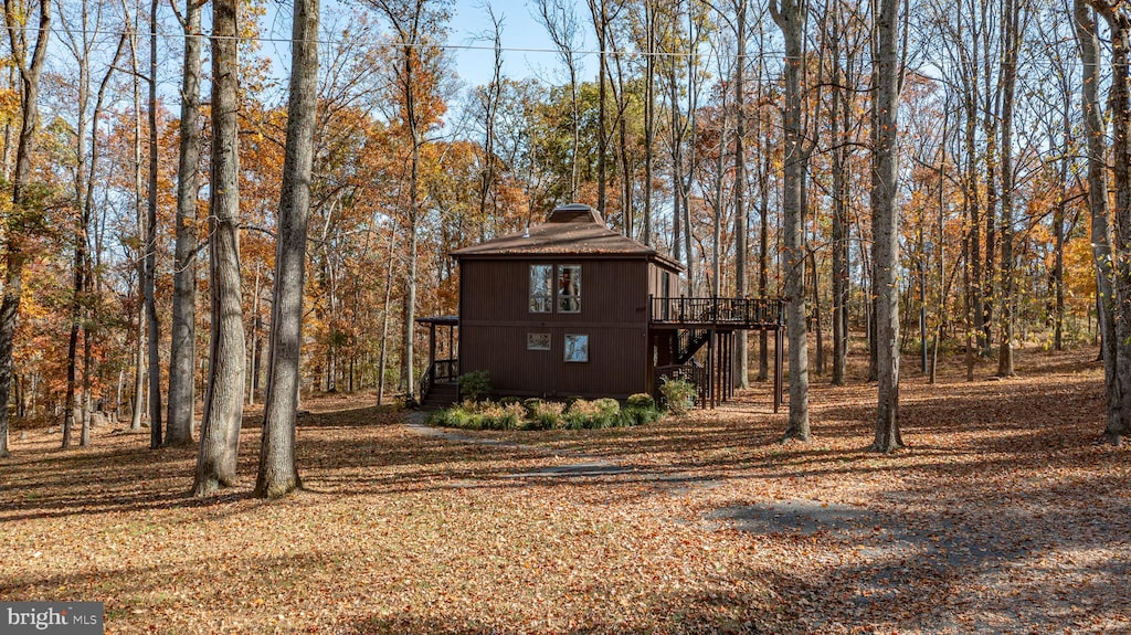 view of property exterior featuring a wooden deck