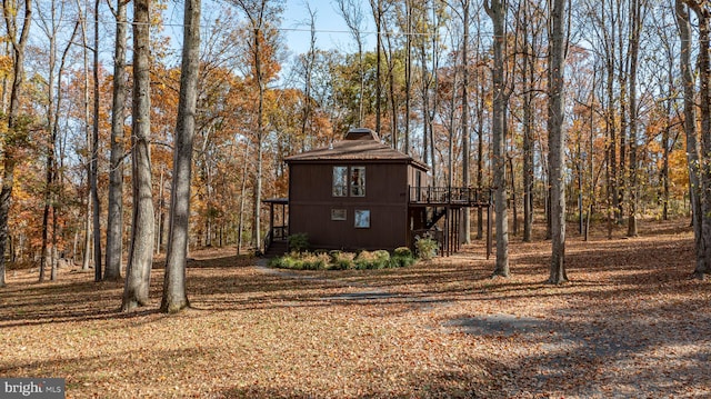 view of property exterior featuring a wooden deck