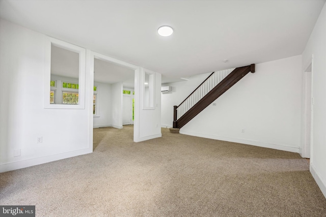 basement featuring light colored carpet and an AC wall unit