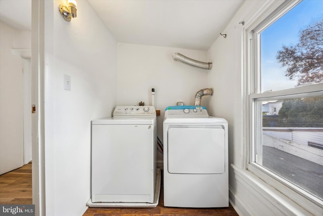 laundry room with washer and clothes dryer and hardwood / wood-style flooring