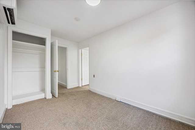 unfurnished bedroom featuring carpet floors and a closet