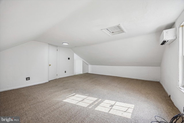 bonus room featuring lofted ceiling, a wall unit AC, and carpet