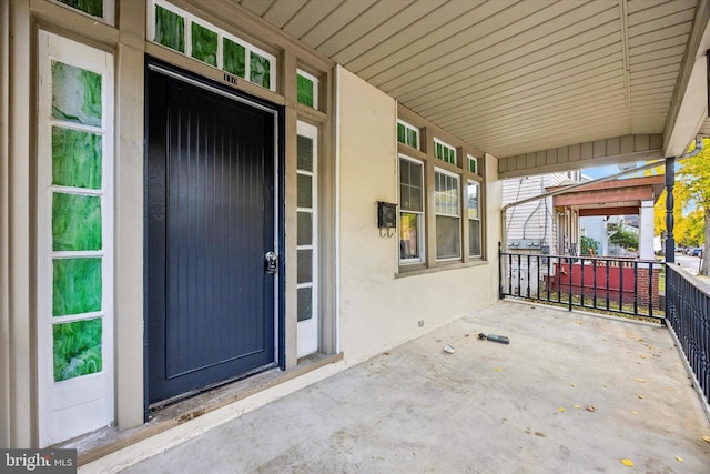 view of exterior entry with a porch