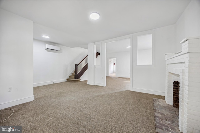 unfurnished living room with a fireplace, a wall unit AC, and carpet flooring