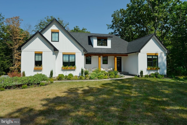 modern farmhouse style home with a front lawn