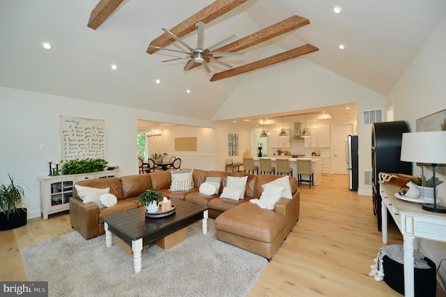 living room featuring light wood-type flooring, ceiling fan, high vaulted ceiling, and beam ceiling