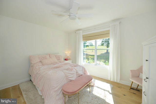 bedroom with light wood-type flooring and ceiling fan