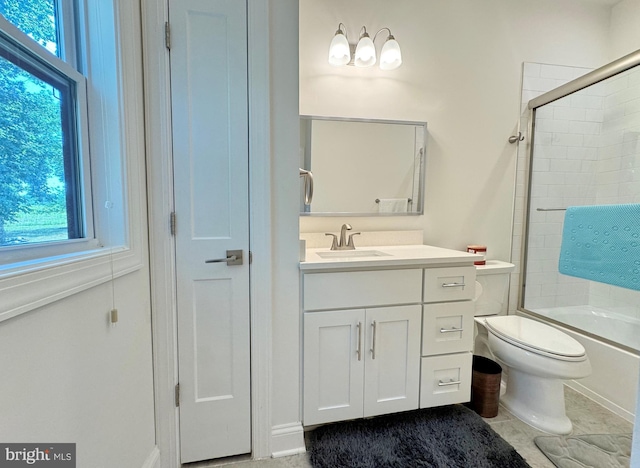 full bathroom featuring toilet, vanity, bath / shower combo with glass door, and a wealth of natural light