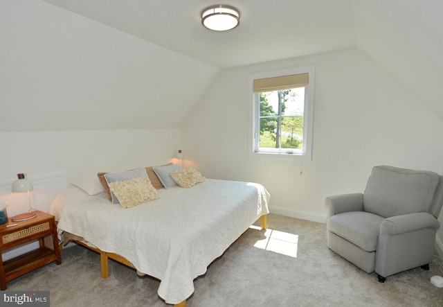 carpeted bedroom with vaulted ceiling