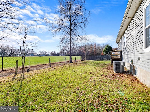 view of yard featuring central AC and a rural view