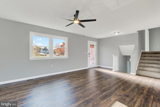 unfurnished living room with dark hardwood / wood-style floors and ceiling fan