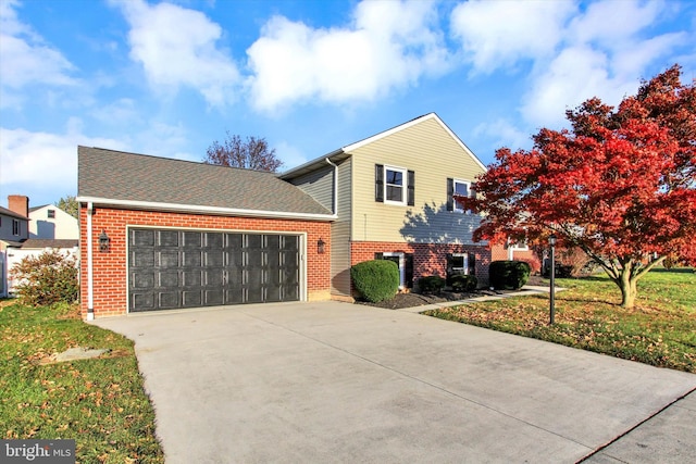 view of front facade with a garage and a front yard