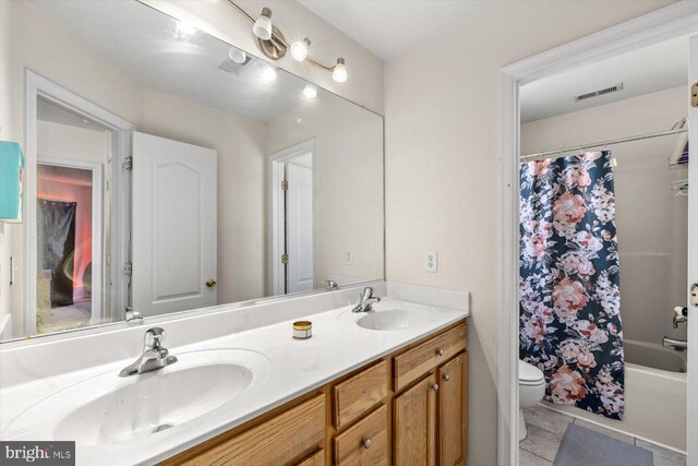 full bathroom with vanity, toilet, tile patterned flooring, and shower / tub combo with curtain