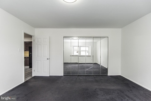 4624 Rhawn St, Philadelphia, PA 19136 - unfurnished bedroom with dark carpet, baseboards, and a closet