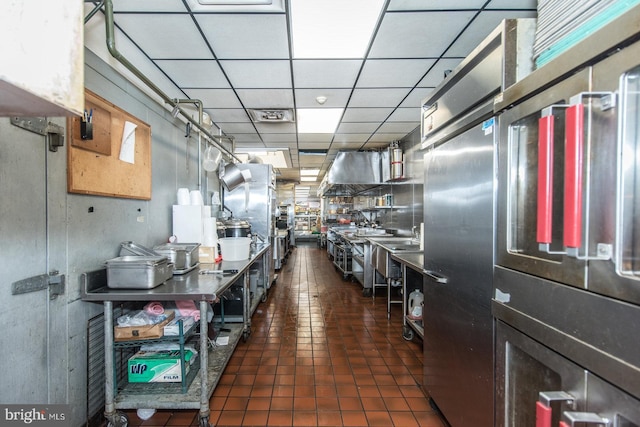 kitchen featuring a drop ceiling and exhaust hood