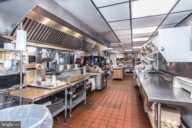 kitchen with white cabinetry, dark tile patterned floors, and stainless steel counters