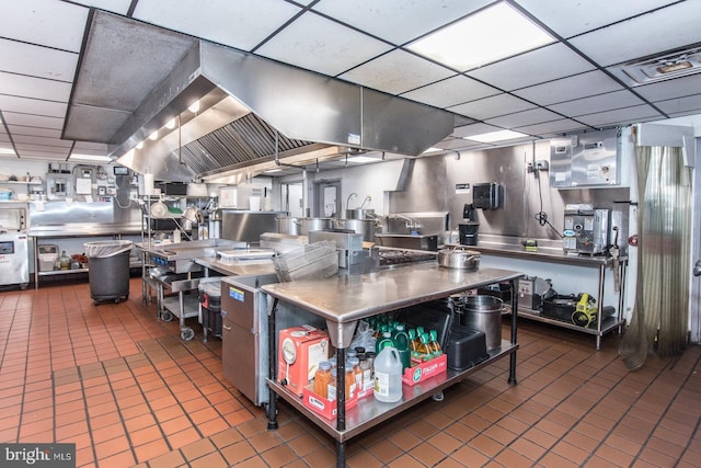 kitchen featuring tile patterned floors, a drop ceiling, visible vents, and stainless steel countertops