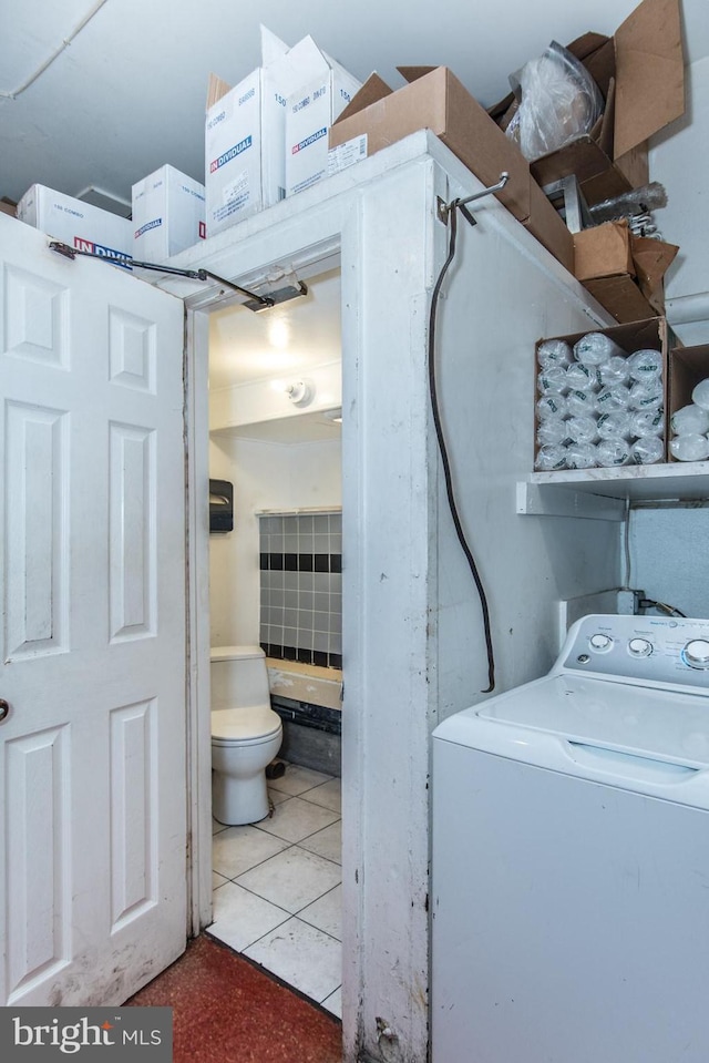 clothes washing area featuring light tile patterned floors and washer / clothes dryer