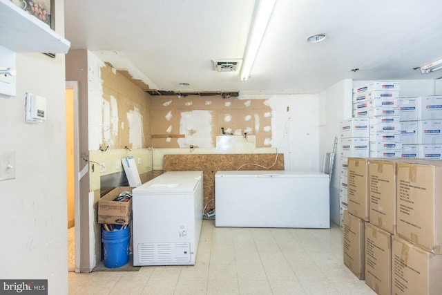 laundry area with washing machine and clothes dryer and visible vents