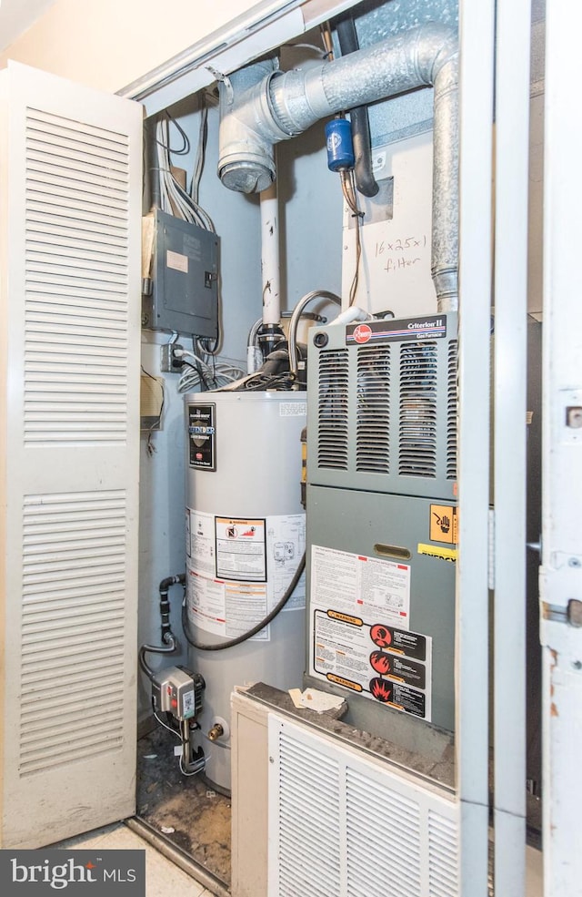 utility room featuring water heater