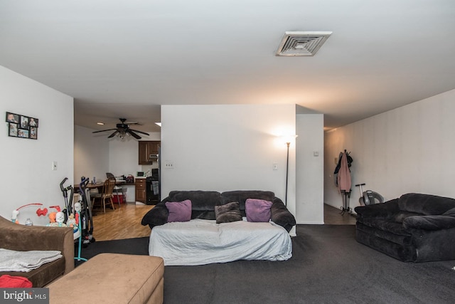 living room featuring visible vents and a ceiling fan