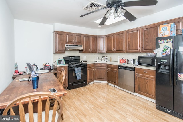 kitchen with sink, ceiling fan, black appliances, and light hardwood / wood-style flooring