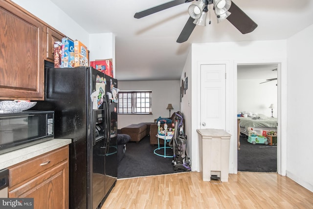 kitchen featuring black appliances and light wood-type flooring