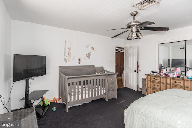 bedroom with a ceiling fan, visible vents, and dark carpet