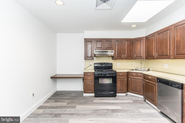 4624 Rhawn St, Philadelphia, PA 19136 - kitchen featuring black range with gas stovetop, dishwasher, under cabinet range hood, a sink, and light countertops